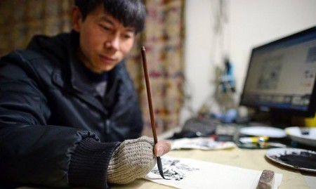张启辉坚强的靠着一根拇指夹画笔作画,以此来养家糊口。(网络图片) 张启辉坚强的靠着一根拇指夹画笔作画,以此来养家糊口。(网络图片)