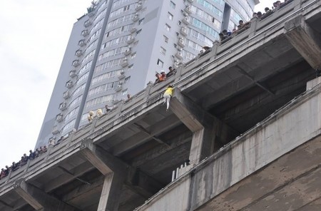 黄衣女子悬在大桥护栏外。（网络图片）