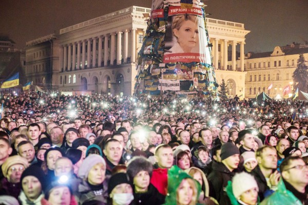 22日晚，乌克兰抗议民众聚集在首都基辅的独立广场，等候刚刚被释放的前美女总理季莫申科。人群中矗立着季莫申科的肖像画。（Getty Images）