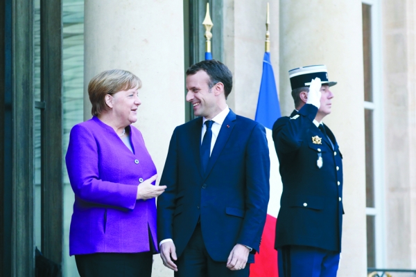 3月16日，法国总统马克龙会见德国总理默克尔。（AFP/Getty Images）