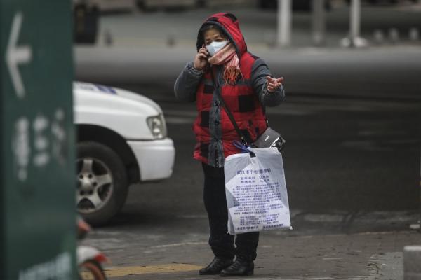 肺炎潜伏期不断延长，网民惊呼：“都没法防了啊！”。图为2月7日，一名戴口罩的老妇在讲电话。（图片来源：Getty Images)