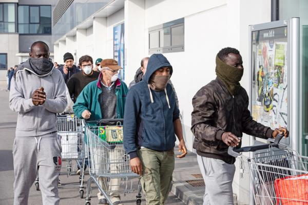 今年疫情暴发初期，意大利人戴着口罩等待进入商场购物。（Emanuele Cremaschi/Getty Images）