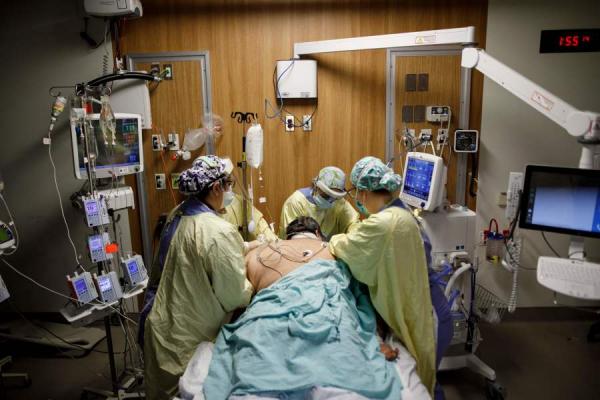 在加拿大某医院ICU病房内，医生在抢救染疫病人。（图片来源：COLE BURSTON/AFP via Getty Images）
