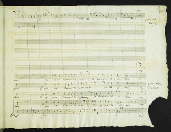 莫扎特《安魂曲》手稿的其中一页，右下角被不知名者撕去。（公有领域）