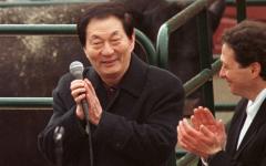 1999年4月11日，中共国务院总理朱镕基（左）在伊利诺伊州利伯蒂维尔的马雷尔巴农场向农民发表讲话时与汤姆·普利兹克一起鼓掌。（图片来源：TANNEN MAURY/AFP via Getty Images）