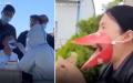 近日网络流传民众为了方便用餐、进行核酸检测，配戴了“鸟嘴口罩”。（图片来源：视频截图）