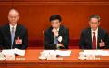 图为2023年3月7日，政治局常委蔡奇（左）、王沪宁（中）和李强（右）出席全国人民代表大会第二次全体会议。