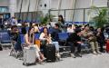 2025年4月12日，旅客们在浙江的义乌机场候机。（图片来源：ADEK BERRY/AFP via Getty Images）
