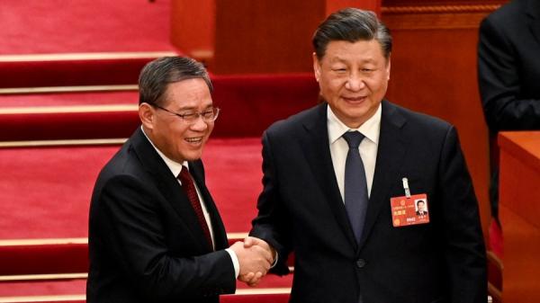 3月11日,习近平和李强在中共全国人大会议上。