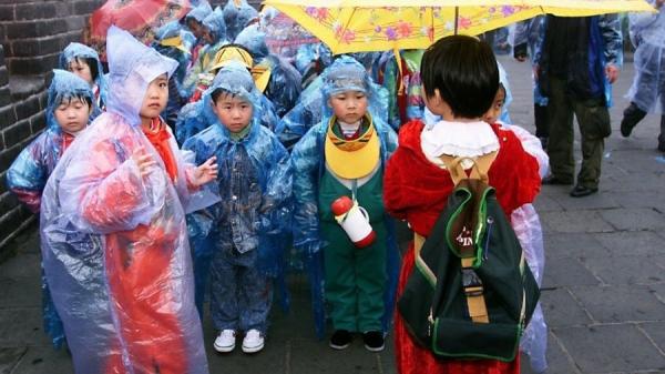 中国孩子冒雨在长城郊游。(图片来源:Getty Images)