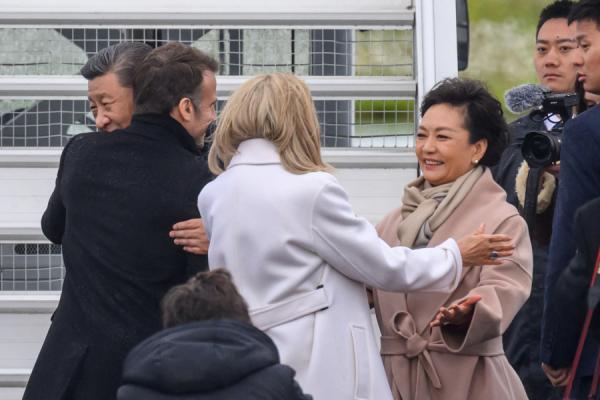 2024年5月7日，中共国家主席习近平和夫人彭丽媛在法国西南部塔布-卢尔德机场出发前拥抱法国总统马克宏和夫人布丽吉特·马克宏。（图片来源：Getty Images）