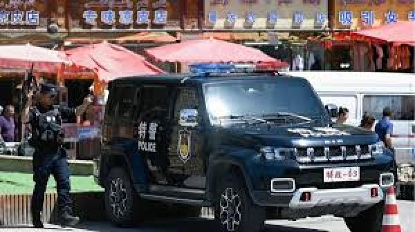 这张照片拍摄于2023年7月15日，显示手持枪支的中共警察在新疆喀什的主广场上站岗。（图片来源：Getty Images）